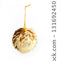 Golden leaf Christmas ornament isolated on a white background.Festive metallic holiday decoration with a leaf texture 131692450