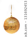 Golden sequin Christmas bauble hanging on a string, isolated on a clean white background. Sparkly holiday decoration. 131692453