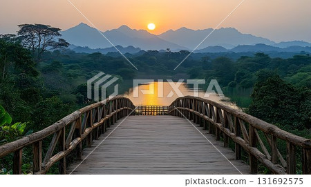 Wooden Bridge at Sunset Over River with Mountainous Backdrop Wooden Bridge at Sunset Over River with Mountainous Backdrop 131692575