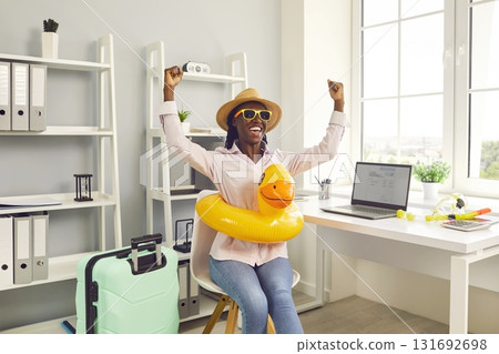 Happy dark-skinned female office manager is going on long-awaited summer vacation. 131692698