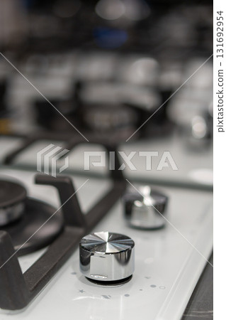 Close-up of modern gas stove flame control knobs. Close-up of modern gas stove flame control knobs. 131692954