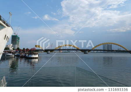 Dragon Bridge in Da Nang Vietnam steel dragon architecture over Han River with LED lights sky reflection and scenic coastal river view 131693336