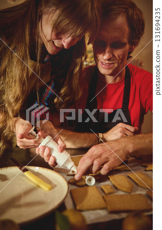 Family And Friends Baking Cookies Together: Warm Kitchen Scene With Icing Decoration And Teamwork Family And Friends Baking Cookies Together: Warm Kitchen Scene With Icing Decoration And Teamwork 131694235