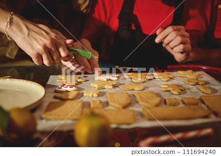 Delicious Moment: Hands Decorate Cookies On Tray With Icing And Festive Shapes 131694240