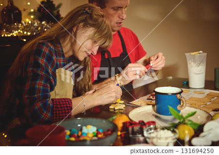 Family Christmas Cookie Night: Couple Decorating Cookies Together During Holiday Baking 131694250