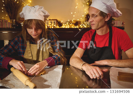 Cooks At Christmas: Father And Daughter Baking Cookies In A Festive Kitchen 131694506
