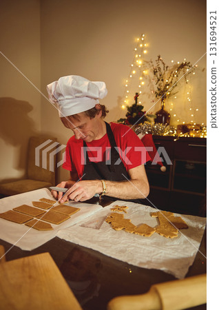 Chef In Christmas Kitchen: Baking Cookies At Home With Gingerbread Shapes And Warm Fairy Lights In The Background 131694521