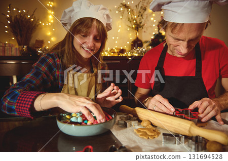 Two Home Chefs Bake Christmas Cookies Together, Wearing Chef Hats, Creating Festive Treats Two Home Chefs Bake Christmas Cookies Together, Wearing Chef Hats, Creating Festive Treats 131694528