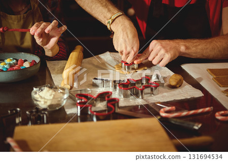 Family Baking Session: Rolling Dough, Cutting Cookies, and Creating Festive Treats Together in a Cozy Kitchen 131694534