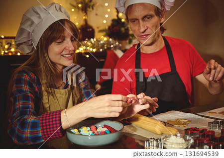 Family And Friends Baking Christmas Cookies In A Cozy Kitchen With Chef Hats Family And Friends Baking Christmas Cookies In A Cozy Kitchen With Chef Hats 131694539