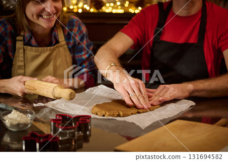 Couple Baking Cookies At Home: Rolling Dough For Christmas 131694582