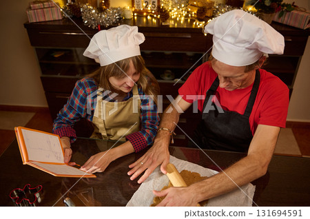 Family Chefs: Father And Daughter Cooking Together In A Festive Kitchen Family Chefs: Father And Daughter Cooking Together In A Festive Kitchen 131694591