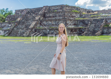 Female tourist standing in front of Teotihuacan pyramids in Mexico, enjoying sightseeing, adventure, and cultural heritage. Travel, tourism, and exploration concept Female tourist standing in front of Teotihuacan pyramids in Mexico, enjoying sightseeing, adventure, and cultural heritage. Travel, tourism, and exploration concept 131694660