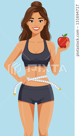 Smiling Fit Woman Measuring Waist Holding Apple 131694717