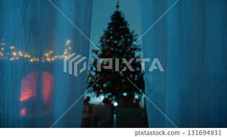 Magical Night And The Beginning Of Christmas Beyond The Curtain Of A Home Window 131694931