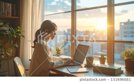 A woman working a side job in a room filled with natural light | A peaceful work-from-home scene 131696081