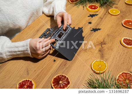 Gingerbread paper house handmade Storytelling creating craft Christmas holiday decoration. Tactile hand-on activity. Master class progress of creative me-made gifts. Seasonal domestic life micro 131696287