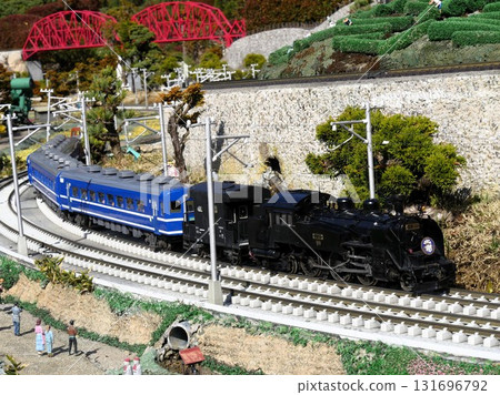 A model of a steam locomotive running through a diorama A model of a steam locomotive running through a diorama 131696792