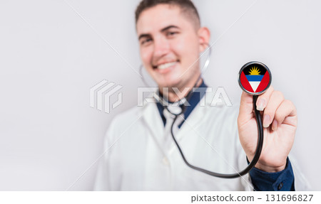 Doctor showing stethoscope with Antigua and Barbuda flag. Antigua and Barbuda national healthcare concept 131696827