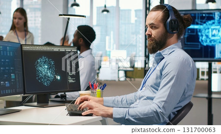 Software developer coding with AI language model assistance in office, listening music. Programmer wearing headphones integrating LLM assistant suggestions into code editor, camera A 131700063