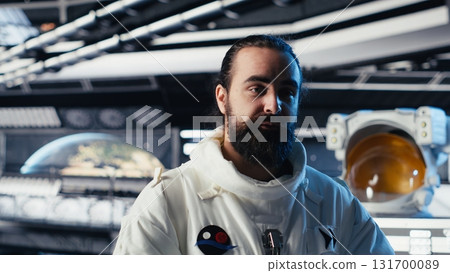 Astronaut studying cosmic origins talks with command center during videocall to share recent discoveries. Cosmonaut mapping unknown worlds provides scientific findings to Earth team Astronaut studying cosmic origins talks with command center during videocall to share recent discoveries. Cosmonaut mapping unknown worlds provides scientific findings to Earth team 131700089