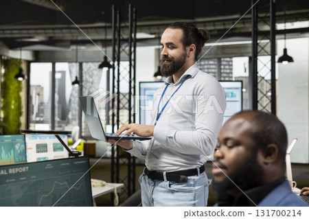 Professional manager prepares data driven reports in the office, analyzing business charts and graphs to develop strategy, improve efficiency and support innovation for corporate achievement. 131700214