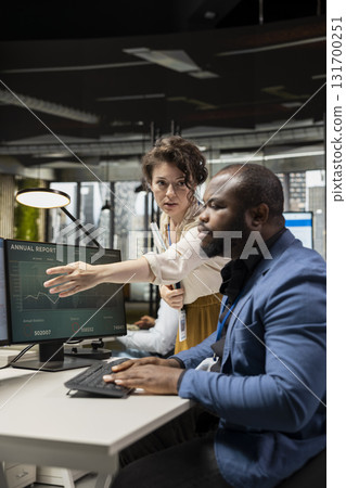 Multiethnic corporate professionals collaborating on business strategy, emphasizing problem solving and corporate growth. People leveraging data analytics to meet key objectives. 131700251