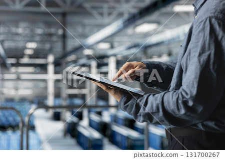 Close up of tablet used by data center technician to manage software updates for system stability. Server room IT expert optimizing performance with device, configuring infrastructure Close up of tablet used by data center technician to manage software updates for system stability. Server room IT expert optimizing performance with device, configuring infrastructure 131700267