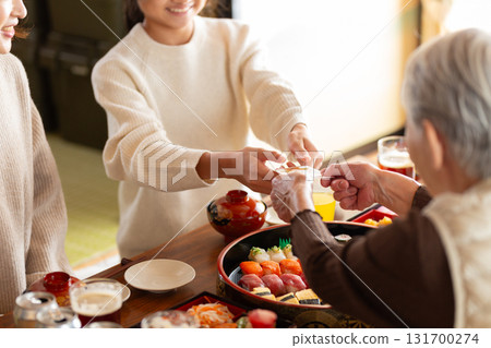 Grandson receiving a New Year's gift from his grandmother at his parents' house during the New Year holidays 131700274