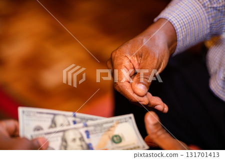 Money currency hands holding cash wedding event dowry payment Kenya Shillings Dollar 131701413