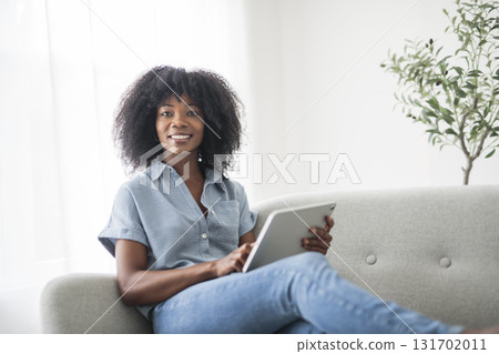business woman on sofa and using digital tablet 131702011