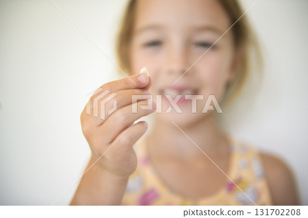 Smiling little girl missing tooth on white background Smiling little girl missing tooth on white background 131702208