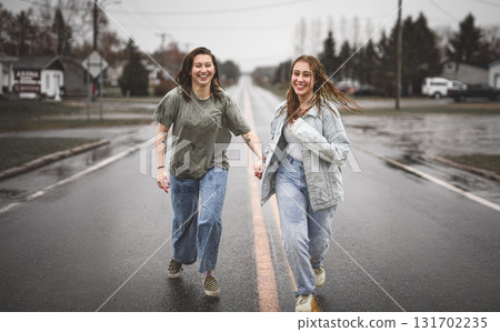 Lesbian Couple Together Outdoors in a rainy day 131702235