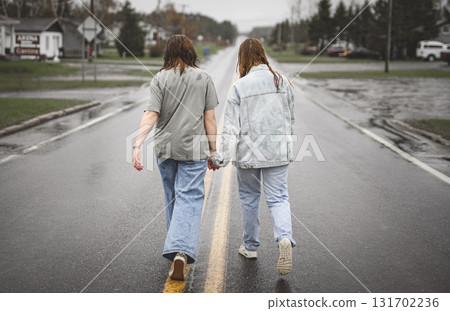 Lesbian Couple Together Outdoors in a rainy day 131702236