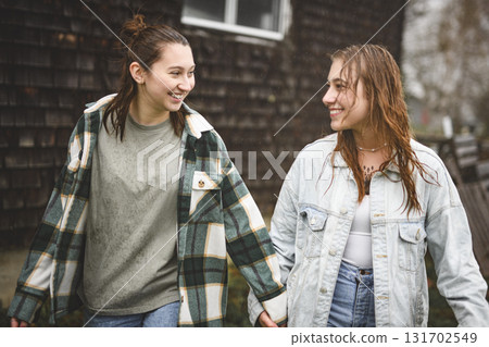 Lesbian Couple Together Outdoors in a rainy day Lesbian Couple Together Outdoors in a rainy day 131702549