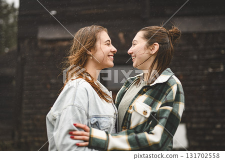 Lesbian Couple Together Outdoors in a rainy day 131702558
