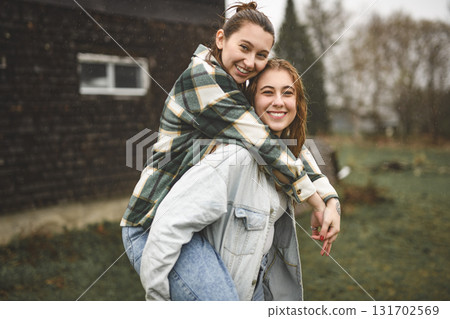 Lesbian Couple Together Outdoors in a rainy day Lesbian Couple Together Outdoors in a rainy day 131702569