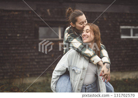 Lesbian Couple Together Outdoors in a rainy day Lesbian Couple Together Outdoors in a rainy day 131702570