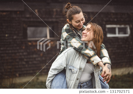 Lesbian Couple Together Outdoors in a rainy day Lesbian Couple Together Outdoors in a rainy day 131702571