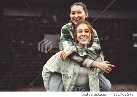 Lesbian Couple Together Outdoors in a rainy day Lesbian Couple Together Outdoors in a rainy day 131702572