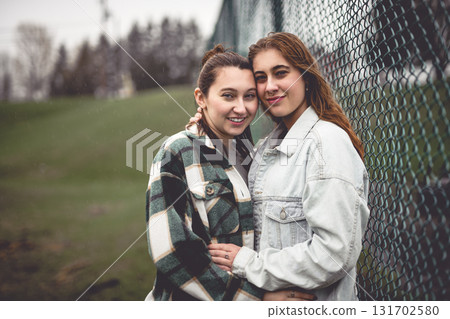 Lesbian Couple Together Outdoors in a rainy day Lesbian Couple Together Outdoors in a rainy day 131702580