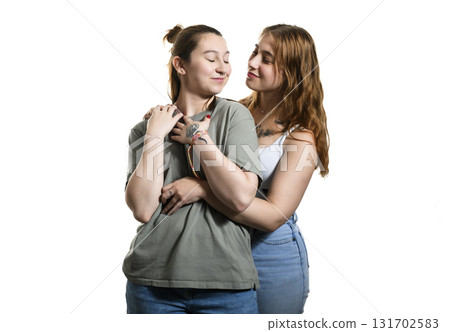 Happy lesbian couple on studio white background. 131702583