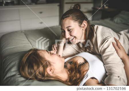 Happy couple having great time close to a window at home 131702596