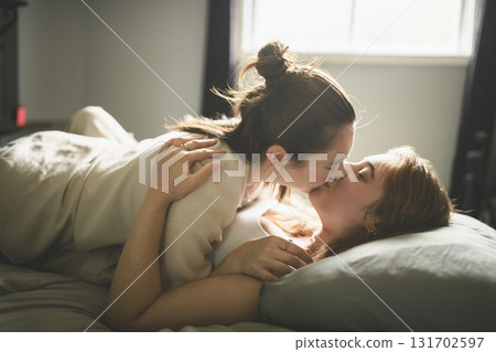 Happy couple having great time close to a window at home 131702597