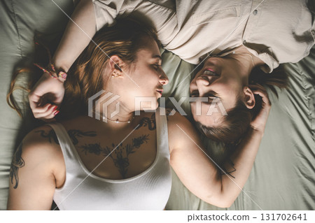 Happy couple having great time close to a window at home Happy couple having great time close to a window at home 131702641