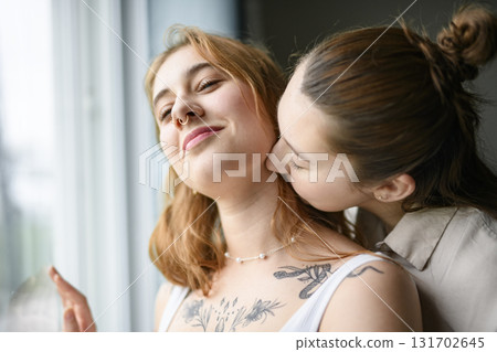 Happy couple having great time close to a window at home 131702645