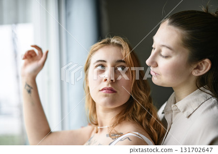 Happy couple having great time close to a window at home 131702647