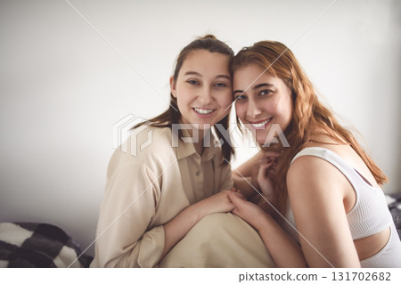 Happy couple cuddling on their bed at home. Romantic young LGBTQ Happy couple cuddling on their bed at home. Romantic young LGBTQ 131702682