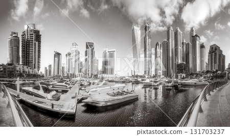 Panoramic view of Dubai Marina bay with yacht and cloudy sky, Dubai, UAE. 131703237