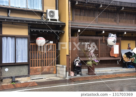 Takayama City, Gifu Prefecture, Japan: During the Spring Takayama Festival, an old house with a hanging lantern and beautiful flowers placed in front of the entrance 131703369